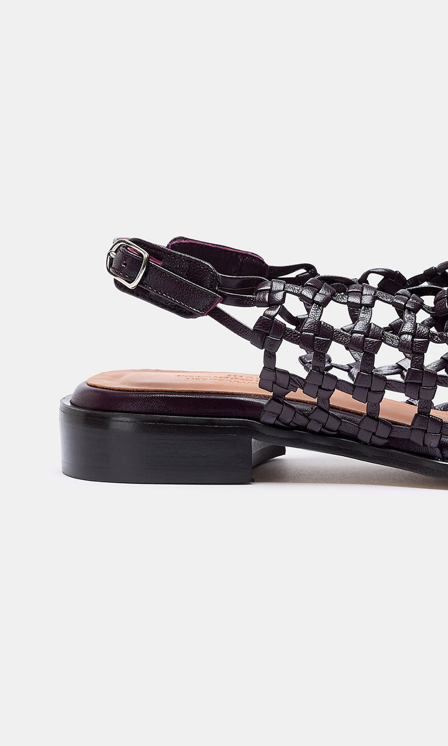 Plümo- Arts Club Sandals: black woven leather with low block heel and ankle strap, handcrafted in Spain, side view on white.