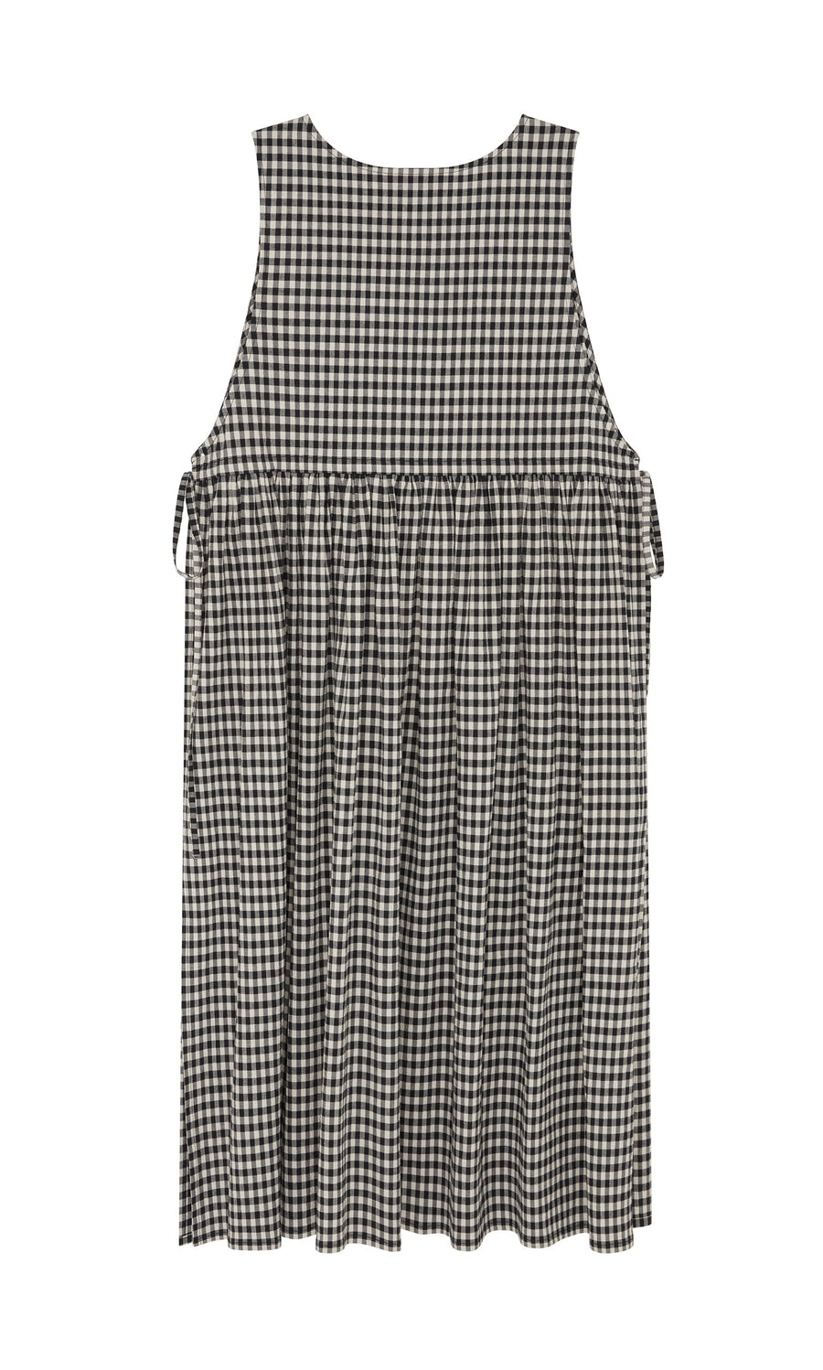 Plümo- The Apron Dress - Gingham features a black and white check, flared skirt, gathered waist, and roomy pockets.