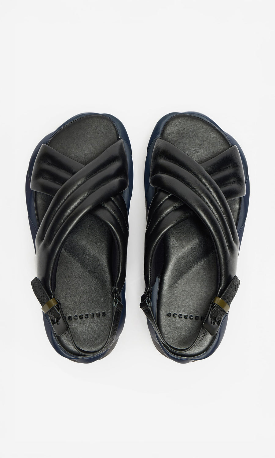 Plümo- Korra Sandals: black, cushioned open-toe sandals with criss-cross straps, shown on a white background.
