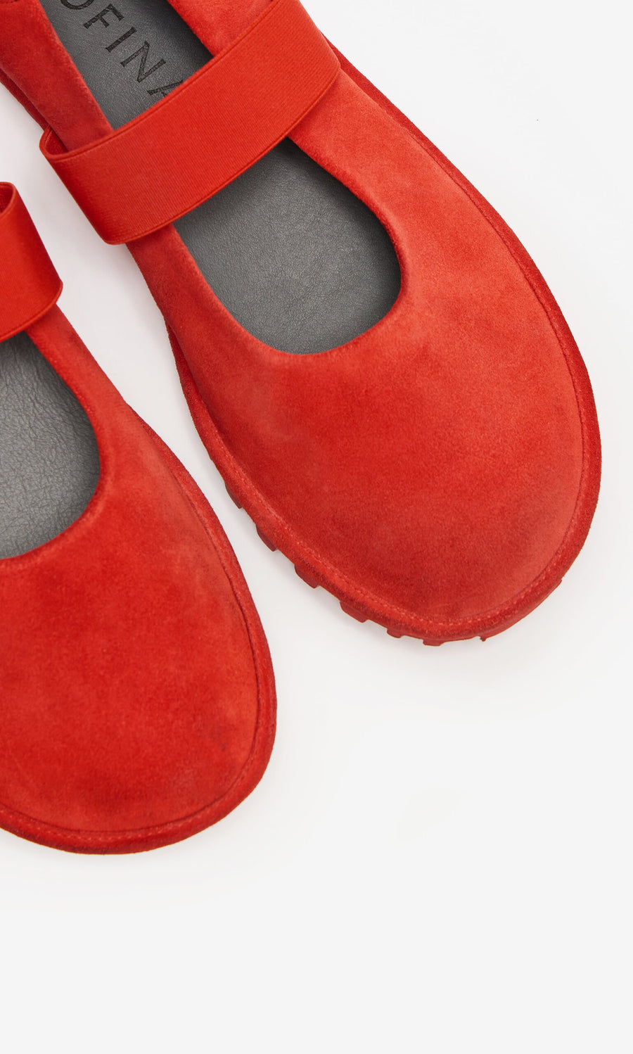 Plümo- Close-up of Sola Red Flats, scarlet suede Mary Jane shoes with a single strap, on a white background.